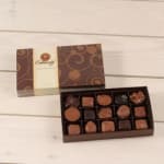 Box of assorted chocolates with a decorative lid