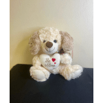 Plush dog holding a heart that says "Be Mine"