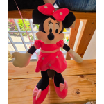 Plush Minnie Mouse doll in a pink dress with a bow