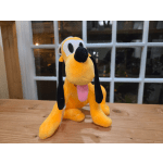 Plush yellow dog with black ears and pink tongue