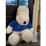 Large Snoopy plush toy wearing a blue shirt that says SMILES