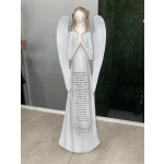 White angel figurine with folded hands and wings, standing on a base with printed text