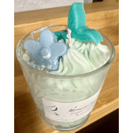 Decorative candle in a glass jar with butterfly-shaped wax toppers