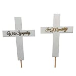 Two white memorial crosses with sympathy wording on stakes