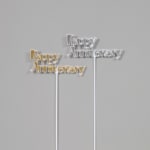 Two Happy Anniversary cake toppers in gold and silver