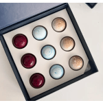 Box of assorted chocolate truffles in red, blue, and gold