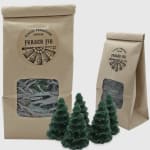 Fraser fir tree-shaped candles in kraft paper bags