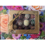 Box of assorted chocolates tied with a gold ribbon