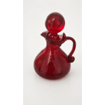 Red glass decorative bottle with a round stopper