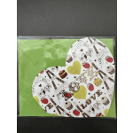 Heart-shaped gift box with patterned lid on green backing