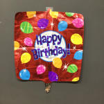 Red birthday balloon with colorful balloon graphics and "Happy Birthday!" text