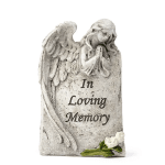 Angel memorial stone with white roses and "In Loving Memory" text
