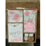Baby clothing gift set in a box with pink floral prints and a onesie reading "worth the wait"