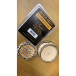 Melted wax melts, a candle tin, and a glass candle jar on a wooden surface