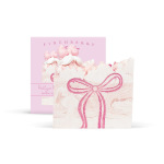 Pink and white soap bars with bow designs in a gift box