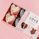 Box of heart-shaped bath bombs in pink and white packaging