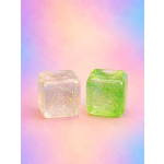 Two glittery cube-shaped glass candle holders on a pastel background.