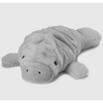Gray plush manatee toy lying on a white background