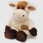 Plush cow stuffed animal sitting on a white background