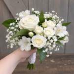 White rose bouquet with baby's breath and green leaves