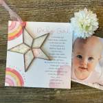 Baby girl greeting card with a star ornament and white flower clip