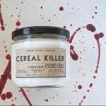 Jar candle labeled Cereal Killer with a black lid