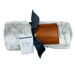 Gray plush blanket tied with a dark ribbon and a sympathy message card