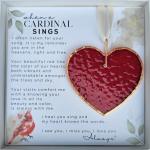 Framed memorial plaque with a red heart ornament and cardinal illustration