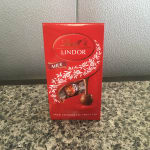 Red Lindt Lindor milk chocolate truffles box on a countertop