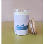 Lavender candle in a glass jar with a wooden lid beside it