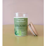 Green cedarwood candle in a glass jar with a wooden lid