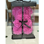 Pink rose-shaped foam teddy bear in a clear gift box with black ribbon