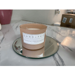Rosewood scented candle in a peach glass jar on a mirrored tray