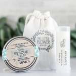 Flower-branded balm tin, soap pouch, and lavender lip balm tube