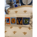 Decorative pillow with colorful block letters spelling LOVE