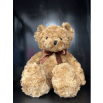 Brown teddy bear with a satin ribbon bow
