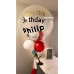 Clear birthday balloon with red and white balloons attached