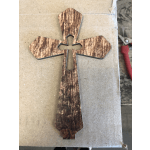 Wooden cross-shaped cutout on a cardboard surface