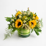 Sunflower and daisy bouquet in a striped glass vase