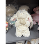 Plush cream-colored lamb toy with pink ears
