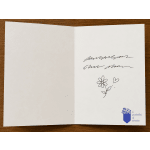 Open blank greeting card with a small flower doodle and logo in the corner