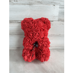 Red rose-shaped teddy bear with a black ribbon