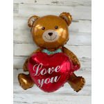 Teddy bear balloon holding a red heart balloon that says "Love you"