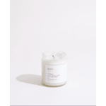 White candle in a clear glass jar with a printed label