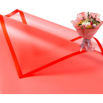 Pink bouquet wrapped in translucent paper beside a matching envelope