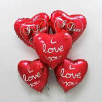Cluster of red heart-shaped balloons with "I love you" text