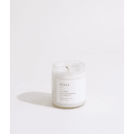 White candle in a clear glass jar with a printed label