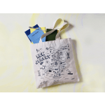 Canvas tote bag with notebooks and a pen inside