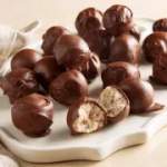 Tray of chocolate truffles, some cut open to show filling