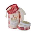 Foot remedy tin and jar with a white plush item draped over them